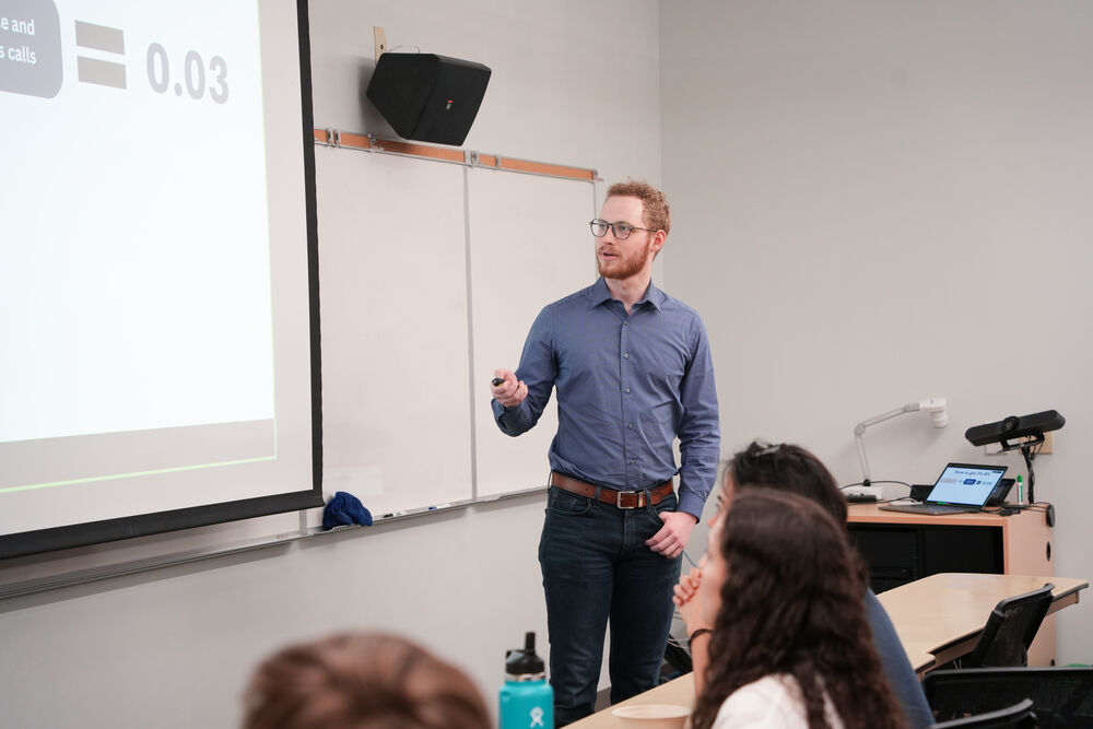 Nathan presenting figures to a classroom